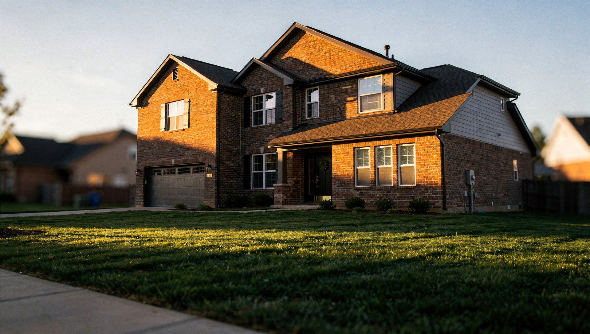 Brick single-family home in the United States at sunset